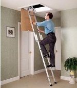 a man using an aluminium loft ladder